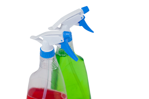 Close-up of detergent spray bottles on white background