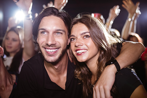 Thoughtful young friends enjoying at nightclub during music festival