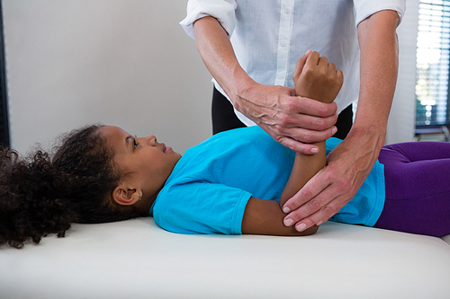 Physiotherapist giving hand massage to a patient in clinic