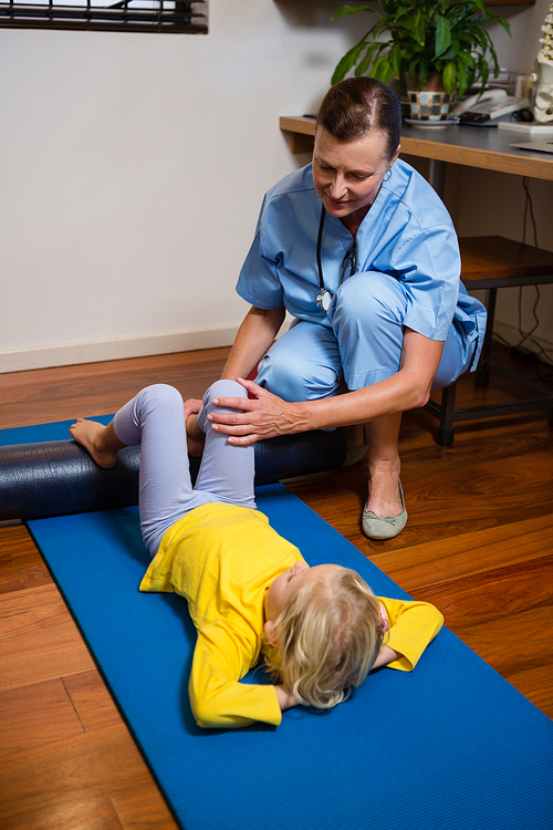 Physiotherapist giving physical therapy to the girl in hospital