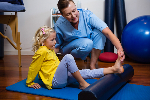 Physiotherapist giving physical therapy to the girl in hospital