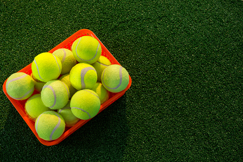 High angle view of tennis balls in container on field