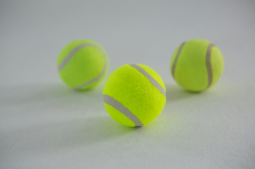 Close up of fluorescent tennis balls on white background