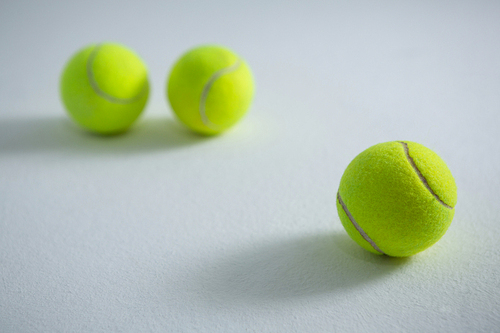 Close up of fluorescent yellow balls on white background