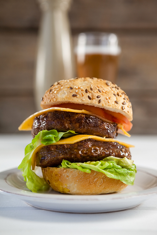 Close-up of hamburger in plate on wooden table