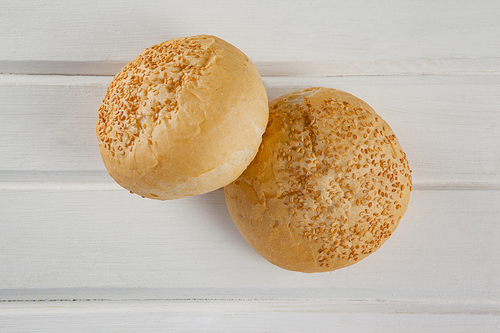 Close-up of two buns on wooden table