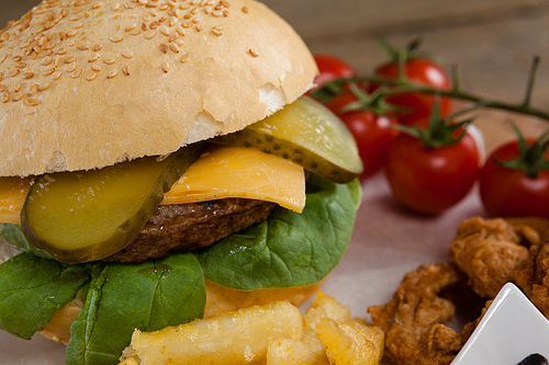 Close-up of hamburger and french fries on wooden table