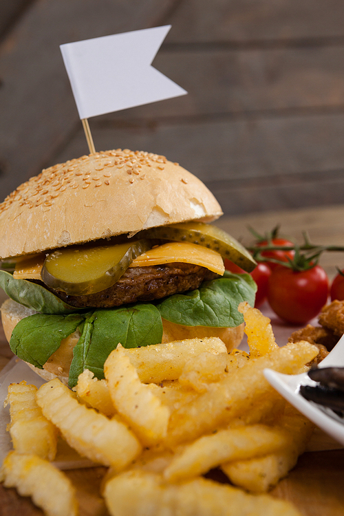 Close-up of hamburger and french fries on wooden table