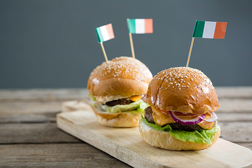 Close up of burgers with Irish flag served on cutting board