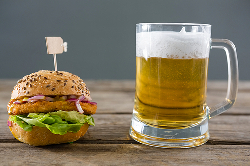 Close up of hamburger with beer glass on table