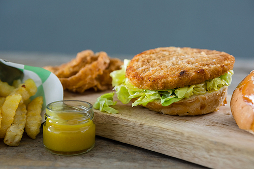 Close up of burger with lettuce on cutting board