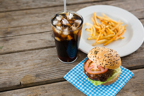 High angle view of hamburger with drink and french fries on table