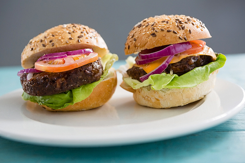 Close up of hamburgers in plate on table