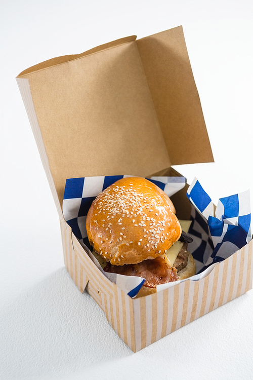 Close up of cheeseburger in box on table