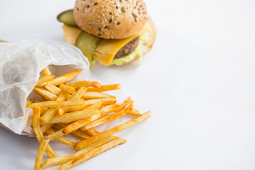 High angle view of French fries by burger on table