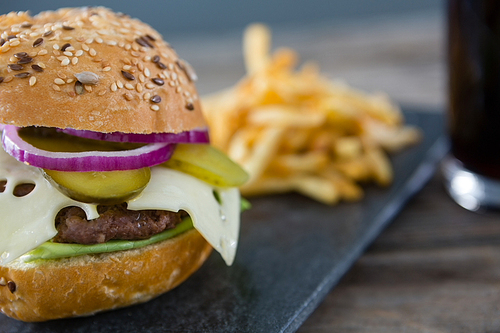 Close up of cheeseburger on slate at table