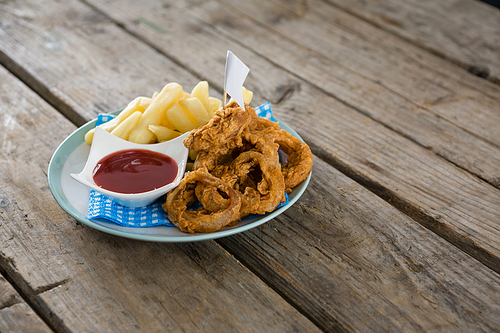 French fries with Onion rings served in plate on table