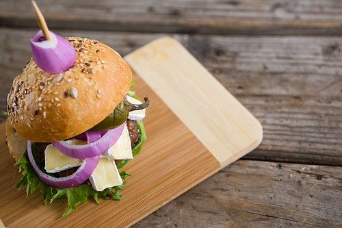 High angle view of burger with cottage cheese on cutting board