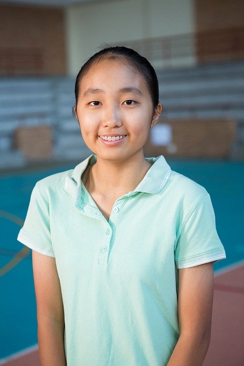 Portrait of smiling volleyball player standing in the court