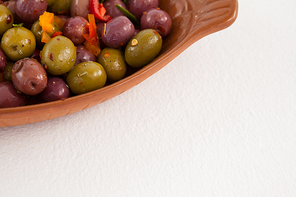 Cropped image of olives served in container on table
