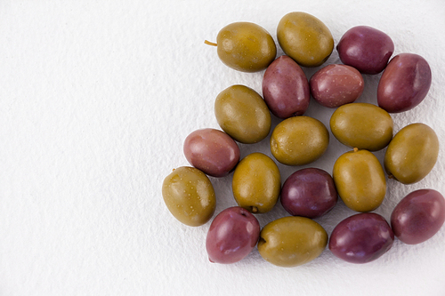 Overhead view of green and brown olives on table