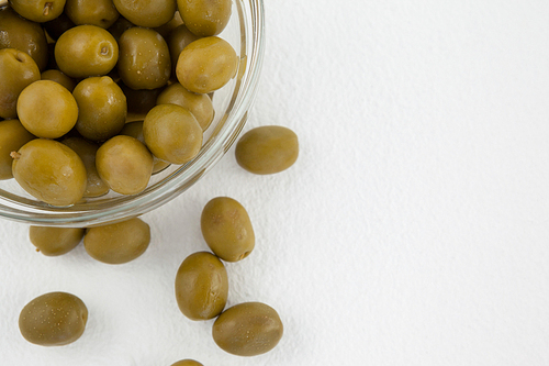 Directly above shot of green olives in bowl on table