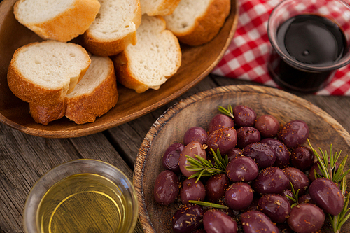 Close up of olives and bread with oil on table