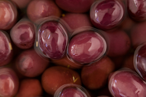 Full frame shot of red olives in oil