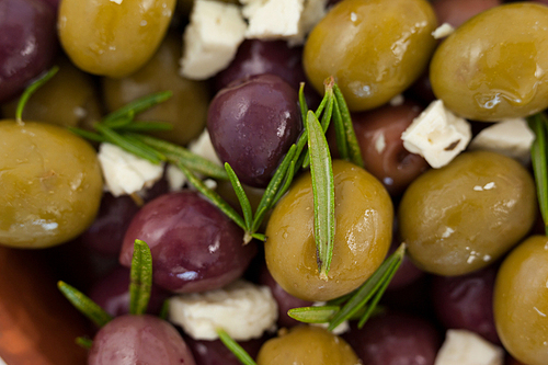 Full frame shot of olives with cheese and rosemary