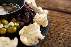 close-up of pickled olives and s surrounded with bread pieces