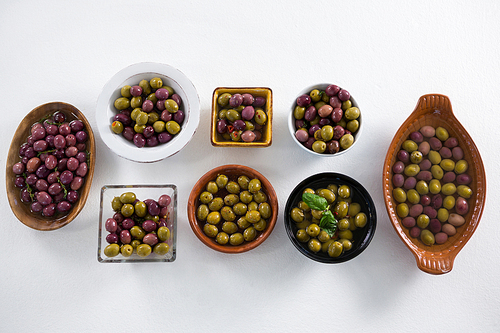 Pickled olives arranged on white background