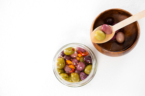 Overhead of marinated olives in bowl and jar