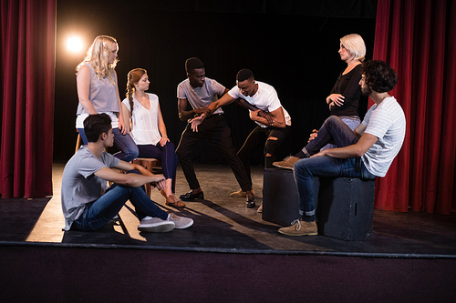 Actors practicing play on stage in theatre