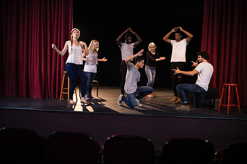 Actors practicing play on stage in theatre