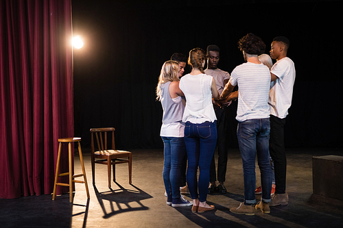 Actors team forming a hands stacked in theatre