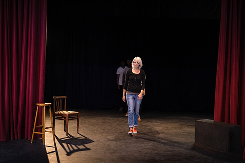 Actors practicing play on stage in theatre