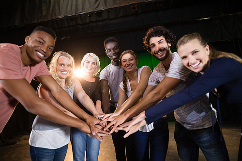 Actors team forming a hands stacked in theatre