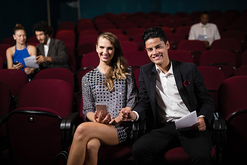 Happy couple watching movie in theatre