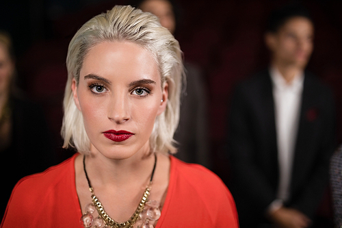 Portrait of woman standing in movie theatre