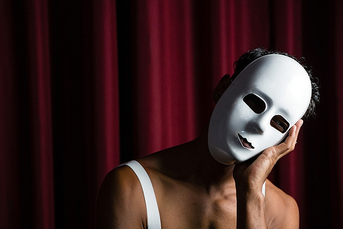 Artist wearing white mask on his face in stage