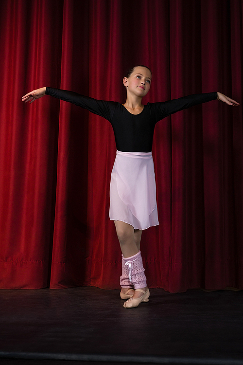 Ballerina practicing ballet dance in the stage