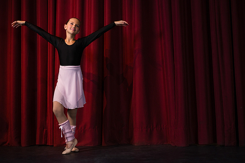 Ballerina practicing ballet dance in the stage