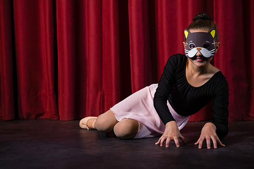 dance dancer wearing mask crawling through the stage curtain