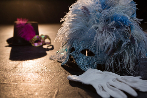 Masquerade masks, gloves and hat on stage