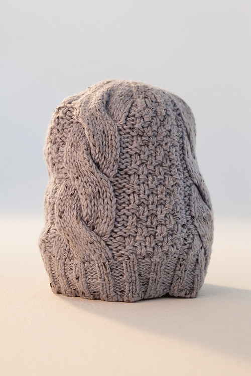 Close-up of wooly hat against white background