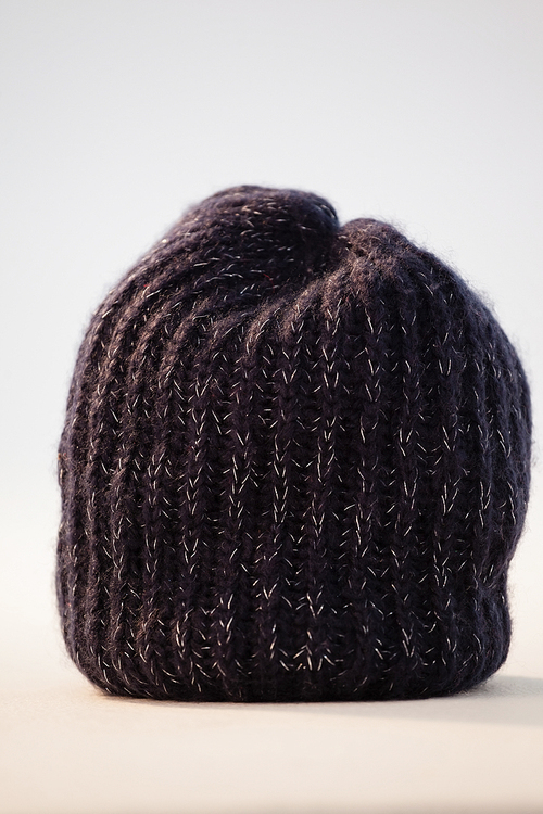 Close-up of wooly hat against white background