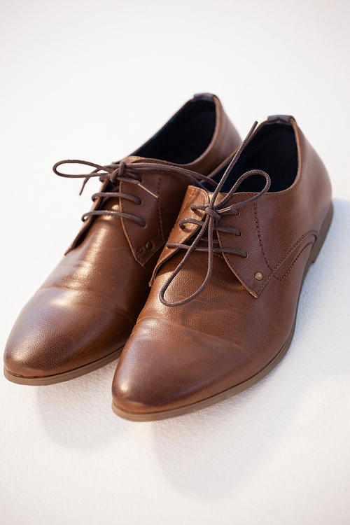 Close-up of shoes pair against white background