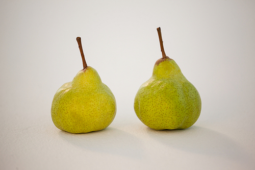 Close-up of two pears against white background
