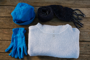 Overhead view of warm clothes on wooden table