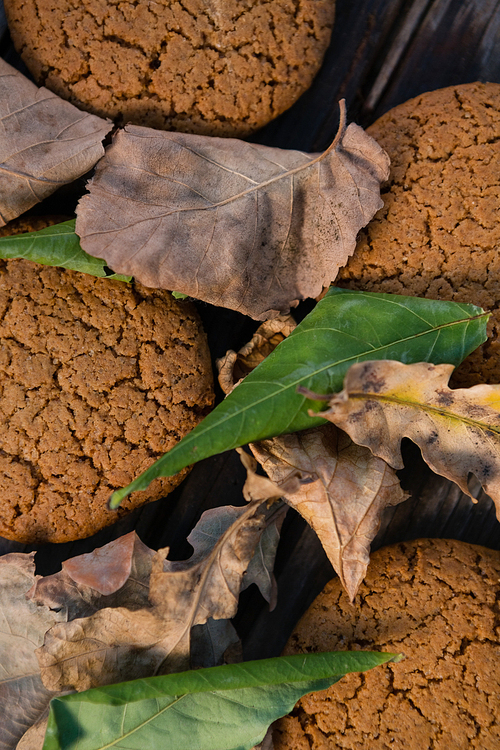 Overhead view of cookies and leaves on table